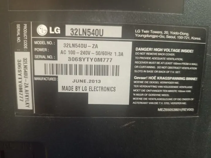 LG TV model label on the back panel during a repair