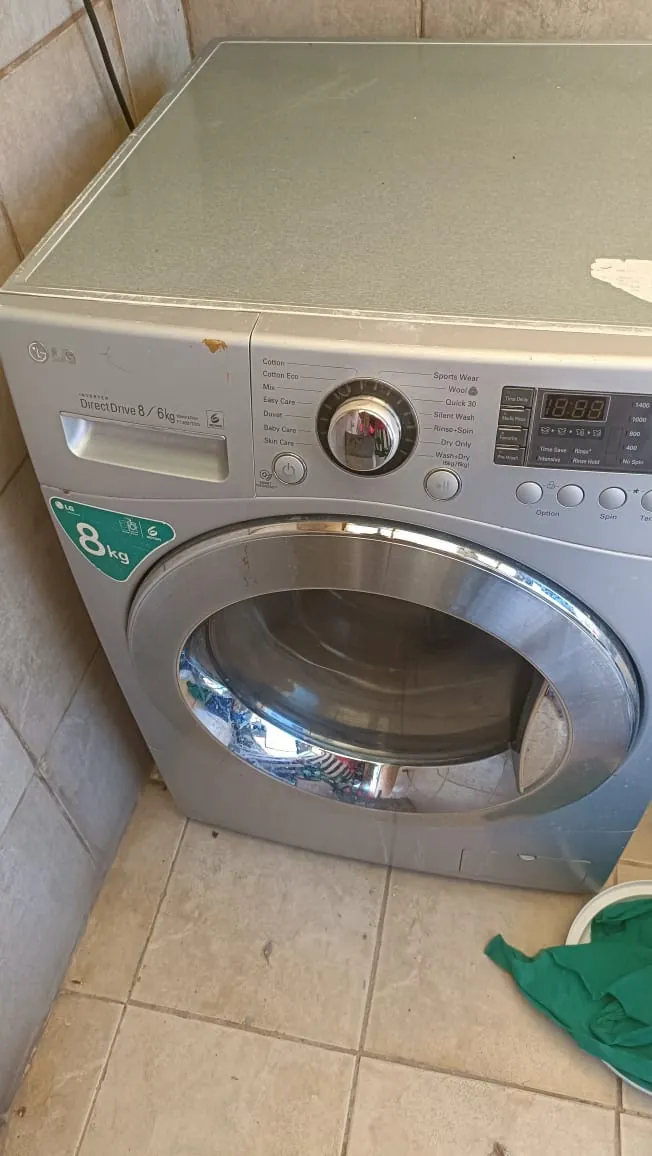 LG 8kg front-load washing machine in a kitchen