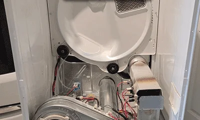 Tumble dryer with the back panel removed showing the drum belt, motor and heater